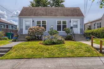 Building Photo - "Charming 3-Bedroom Duplex with Granite Touches & Gleaming Hardwood Floors in Seattle's Vibrant B...