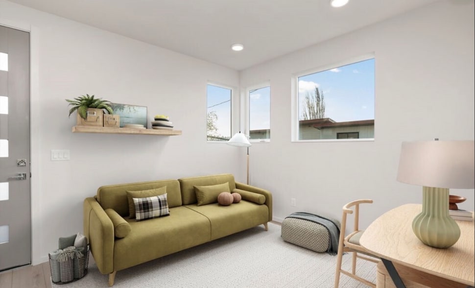 Open living area with strong natural light and room for flexible use. - 2921A Franklin Ave E