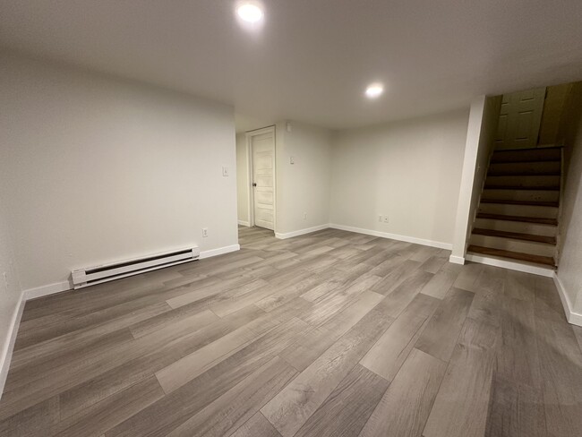 Stairs from exterior door to basement unit entering the living room - 1137 E Platte Ave