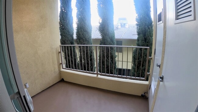 A patio to enjoy the SoCal Weather! In Unit washer and dryer are located past these white doors! - Haleakala Luxury Apartments