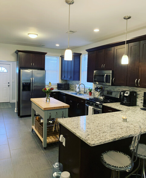 High end kitchen with stainless appliances and granite counter tops. - 74 Peters Pl