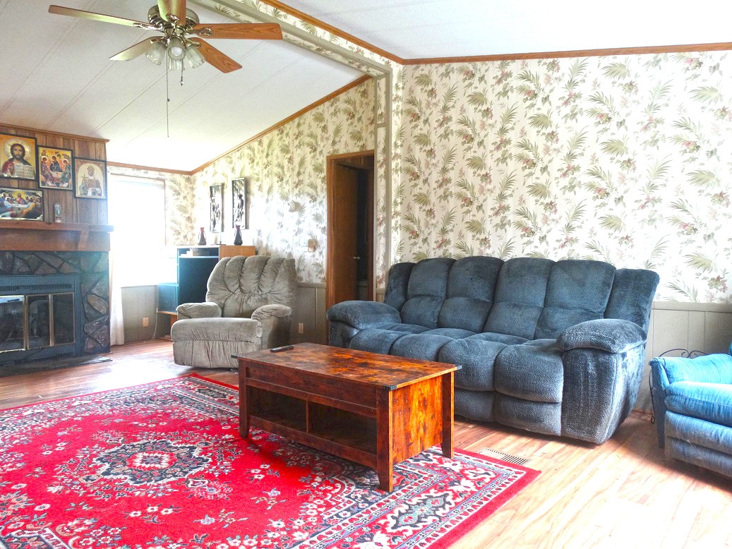 Living room features decorative fireplace with mantle - 118 W Rogers St