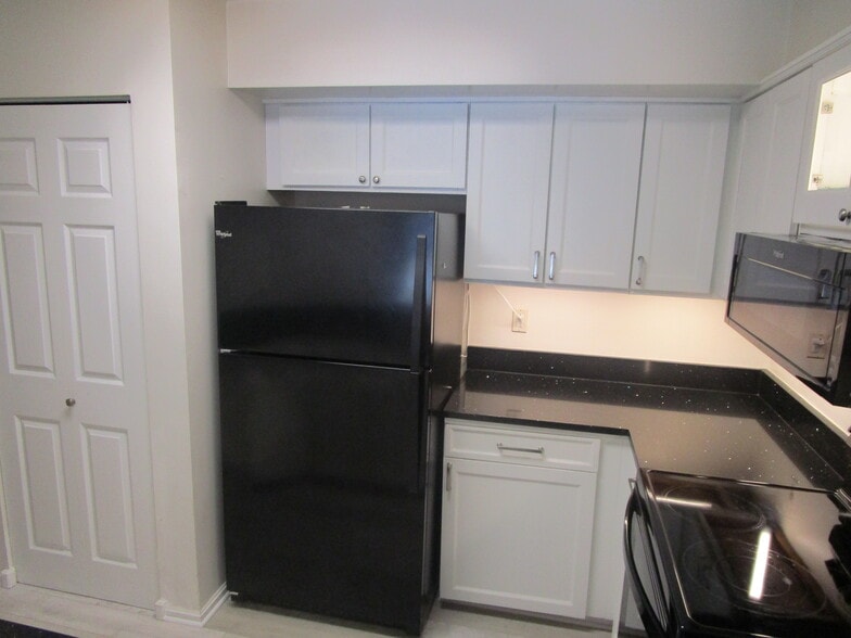 kitchen with new fridge - 2100 Langston Blvd