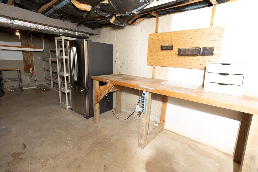 Basement with Work Bench and Additional Fridge - 16003 Fairway Dr