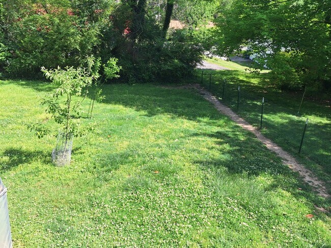 Building Photo - Cute white cottage with white picket fence & Huge deck off back door!