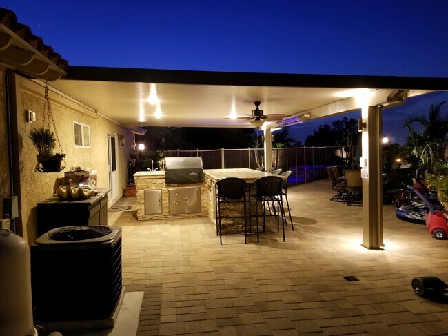 outdoor entertaining area at night - 3027 Oakwood Ln