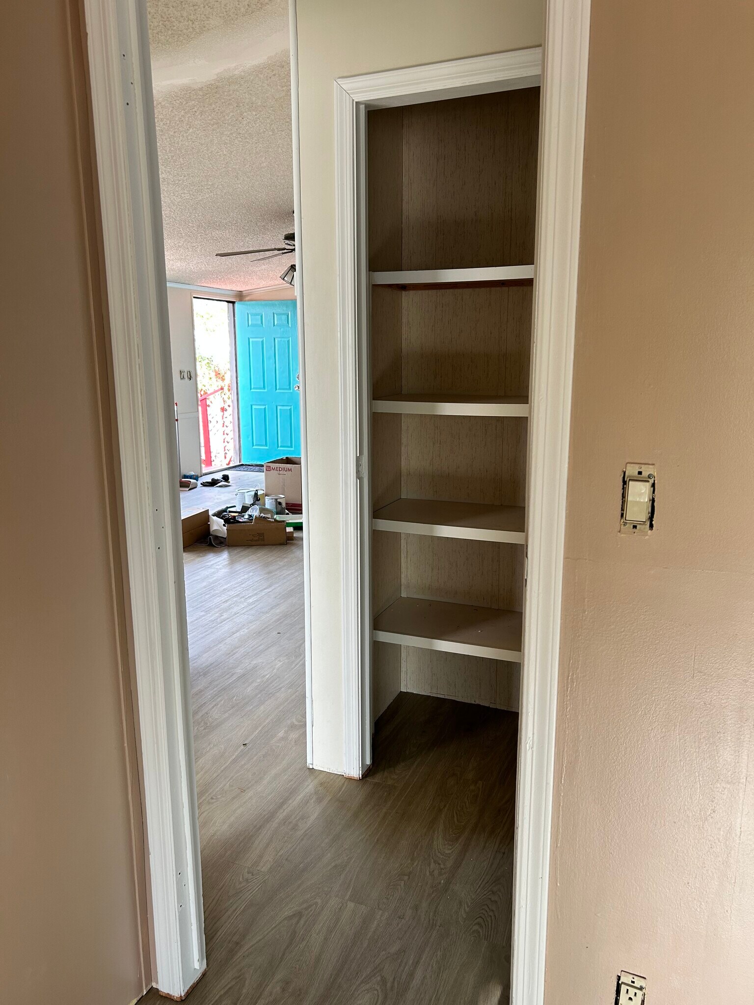 Linen closet looking into living room and front door. - 917 Castle Rock St