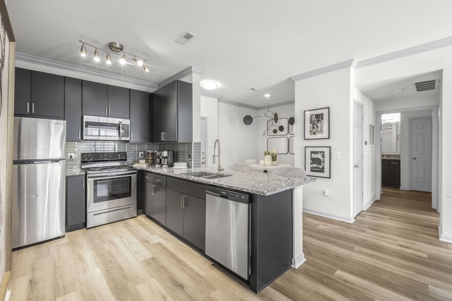 Two Bedroom - kitchen with stainless steel appliances and granite countertops - Meridian at Grandview