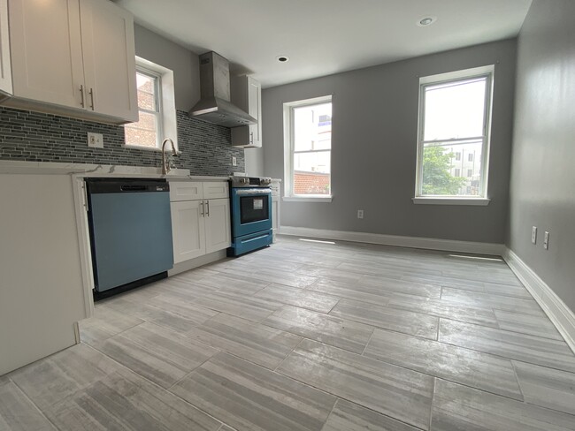 Large sunny modern white kitchen, quartz countertop, porcelain tile floor, stainless steel appliance - 1618 Fitzwater St