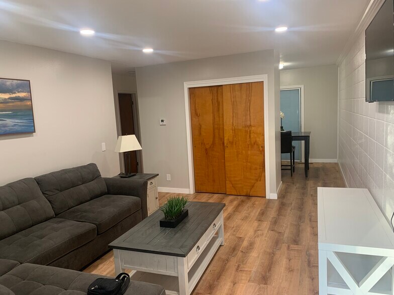 Living room has recess lighting with sectional couch, coffee table, in table, console, television - 896 Raymond Dr