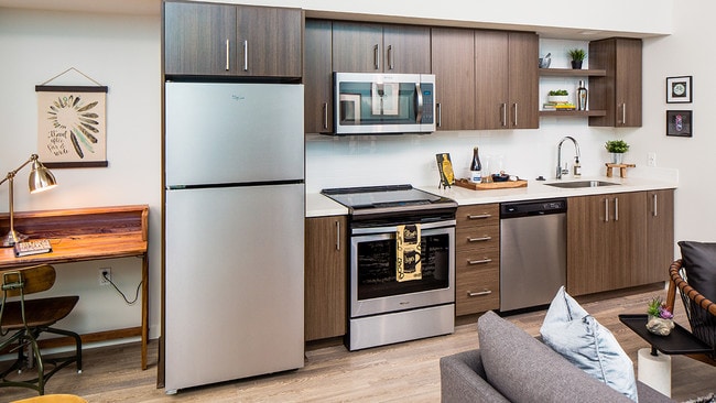Contemporary kitchen design featuring stainless steel finishes and open shelving. - Modera Belmont