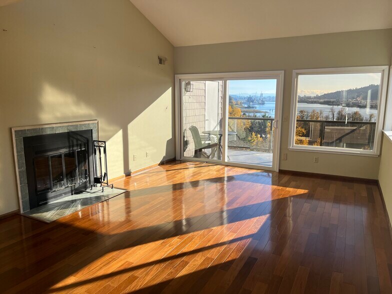Living room with view of fireplace and deck - 7511 N Edgewater Ave