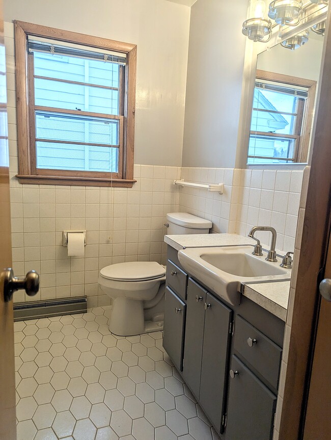 Honeycomb tiled floor with tiled in tub/shower. This bathroom also has a built in heated fan! - 910 Maple St