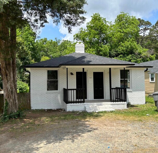 Both doors have access to the house. Right side to living room and left is a bedroom or living space - 305 Orange St