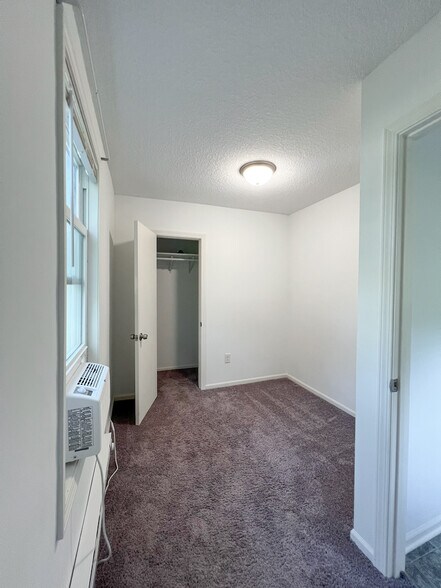 Bedroom fits a twin or full. A queen or larger will block the closet. - 16610 8th St N