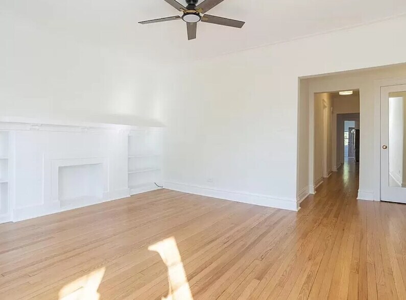 Living room with decorative fireplace and built in shelves - 6513 N Bosworth Ave
