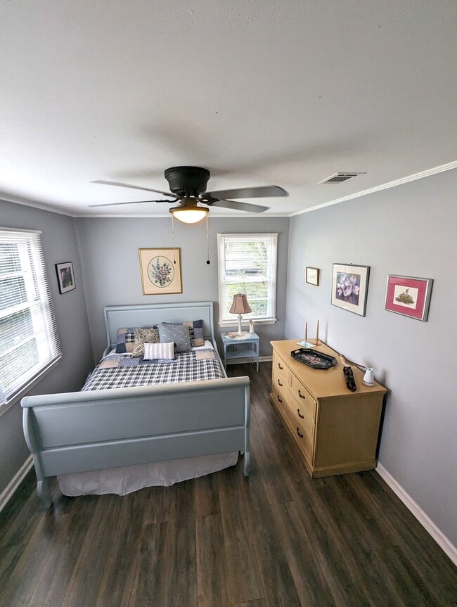 Bedroom 2 is warm and cozy. Queen bed, original art and a closet. - 4107 Crane St