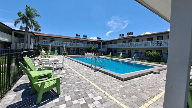 Large Pool and Deck with Tables, Chairs, Loungers and Umbrella's - 5600 N Banana River Blvd