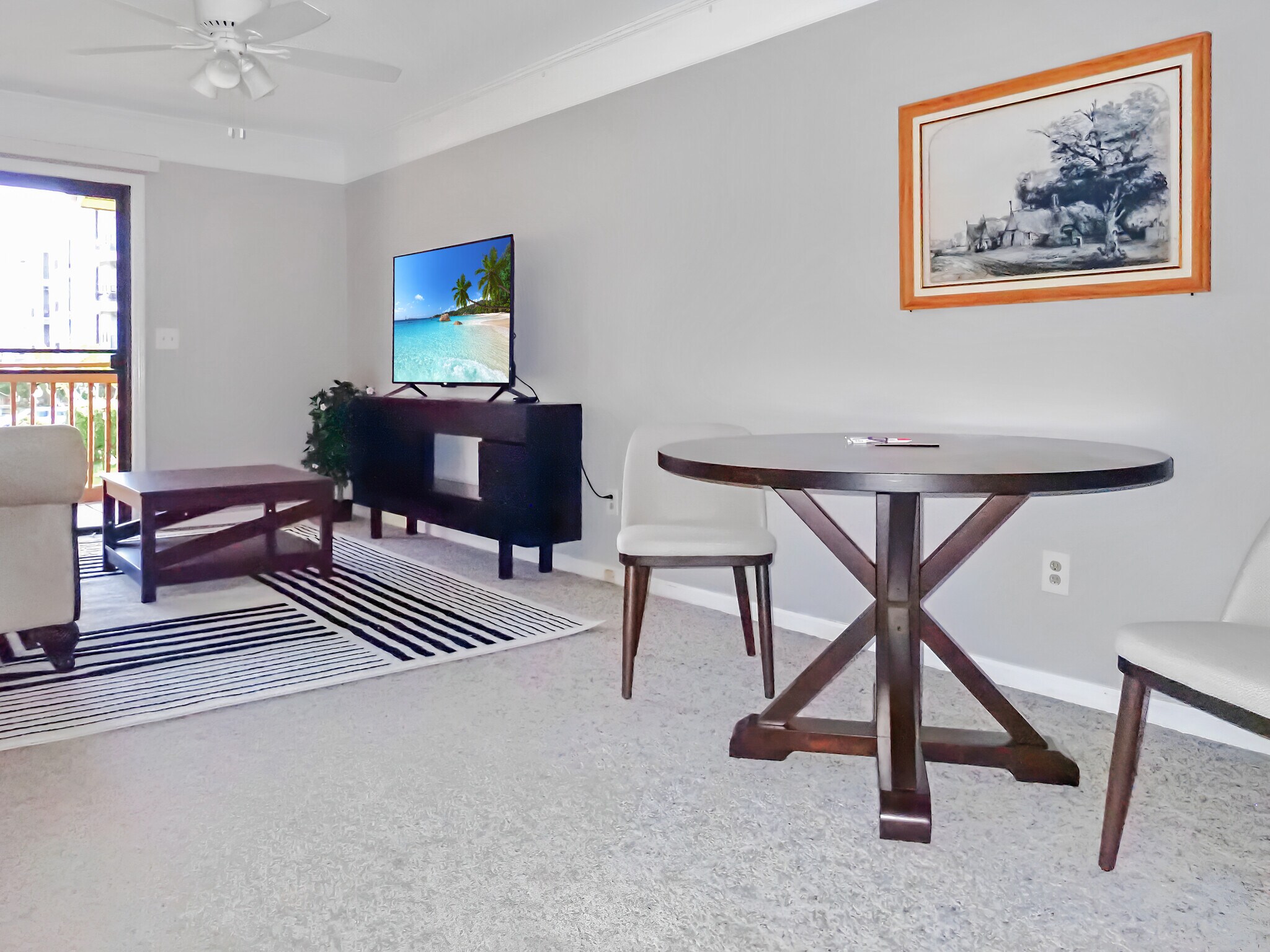 Living room includes new furniture, 55" Roku TV, south-facing patio. - 3601 Saint Johns Ct