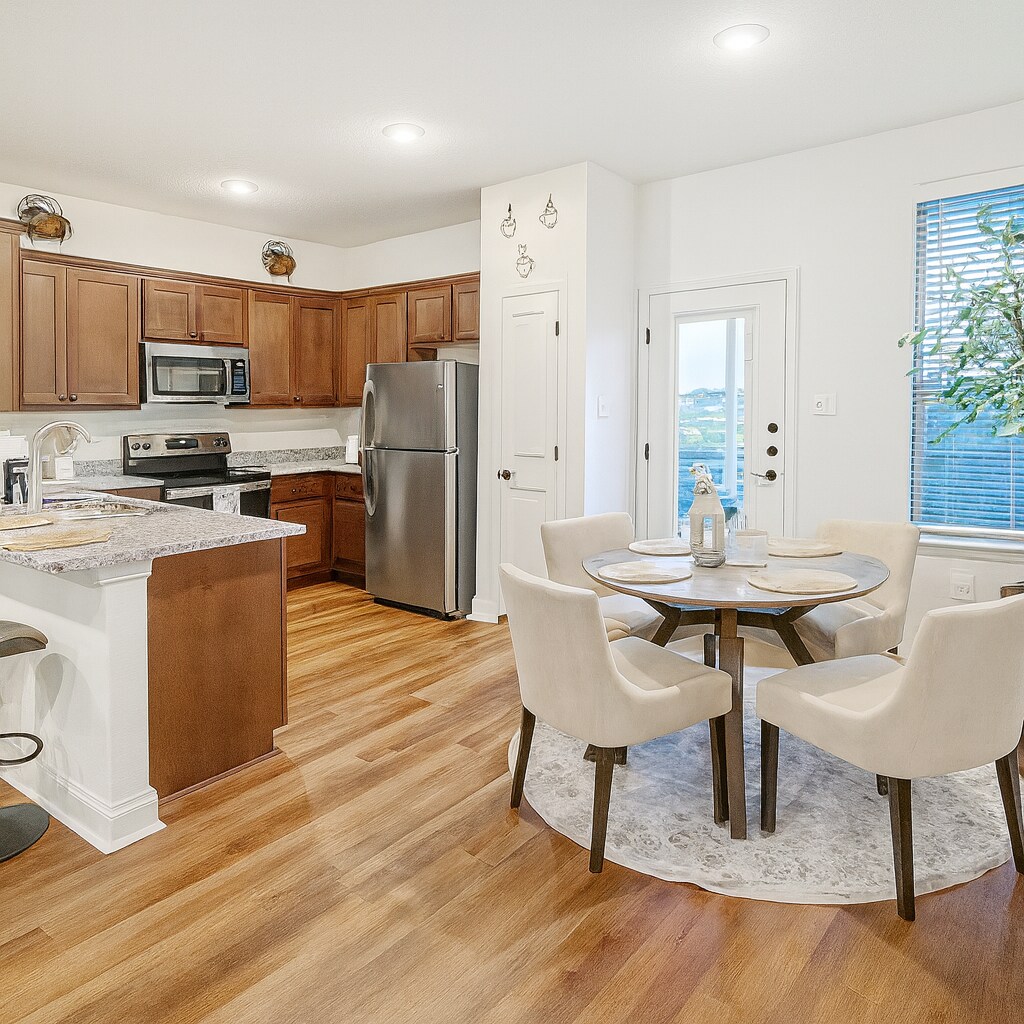 Kitchen. This home is offered unfurnished. Staging furniture shown is not included. - 13810 Enzo Gate