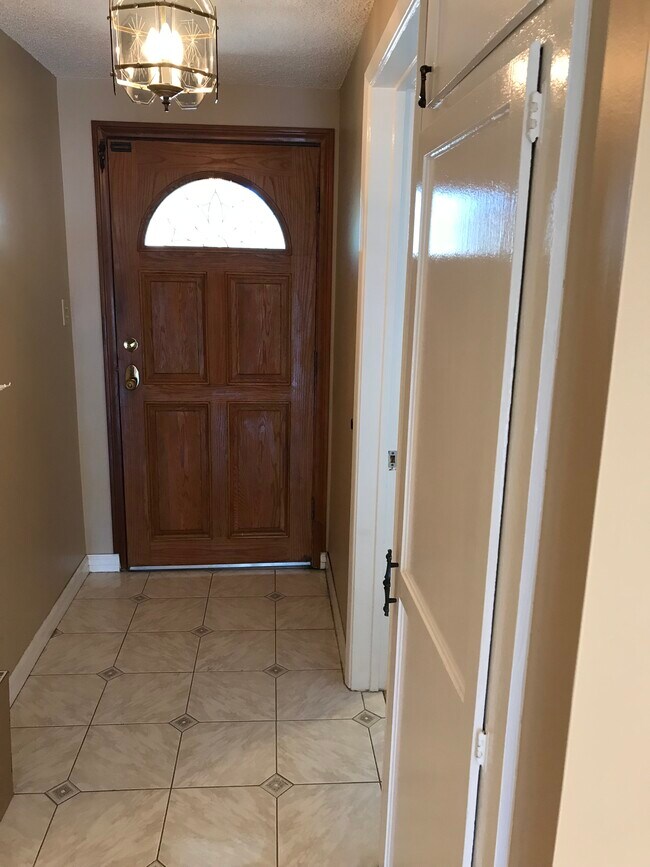 Front entryway with tiled floor and coat closet. - 14911 Fonthill Ave