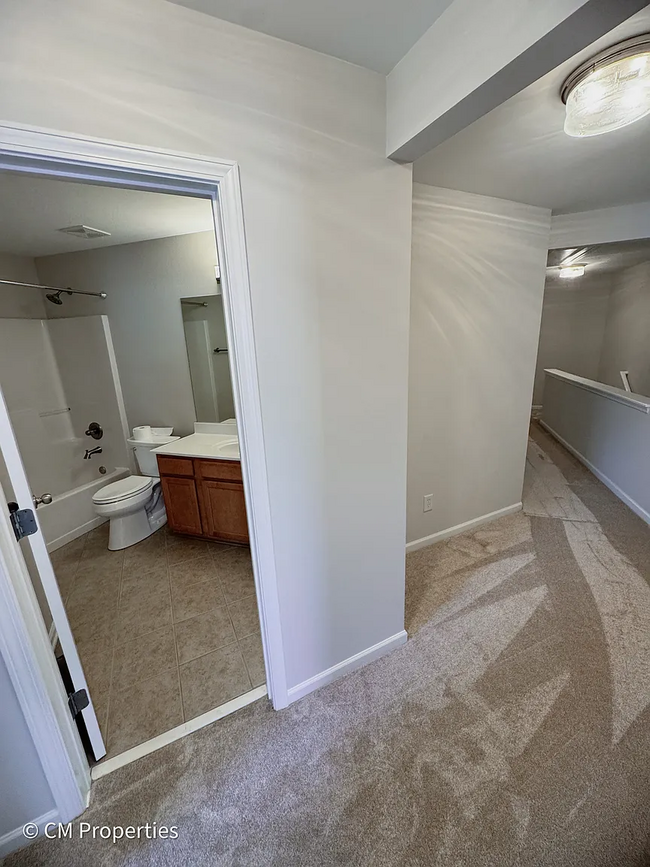 Hallway from 2nd Bedroom. Laundry to right, 3rd Bedroom on left. - 3968 Boston Common St