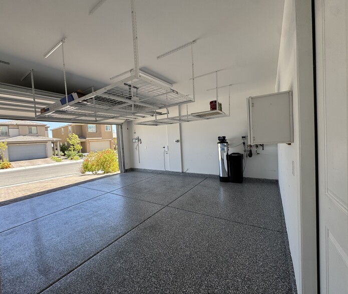 Garage with EV, epoxy floors and overhead storage - 331 Coastal Redwood St
