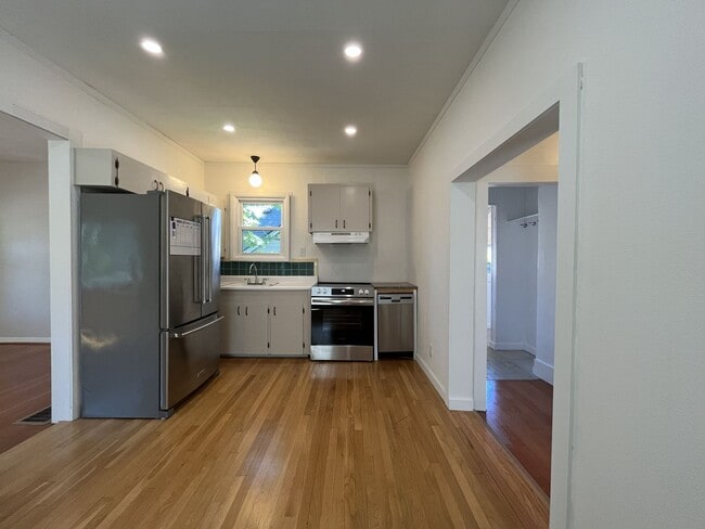Building Photo - Charming Cottage with Hardwood Flooring, Modern Kitchen & Beautiful Outdoor Living Areas