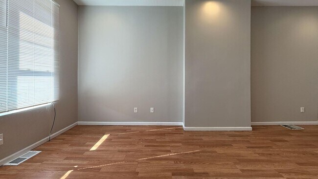 Building Photo - Charming 4BR/2BA Rowhouse with Hardwood-Style Flooring Throughout