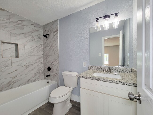 Building Photo - This beautifully updated 4-bedroom home is just under two miles from Highway 288 and Loop 610, ma...