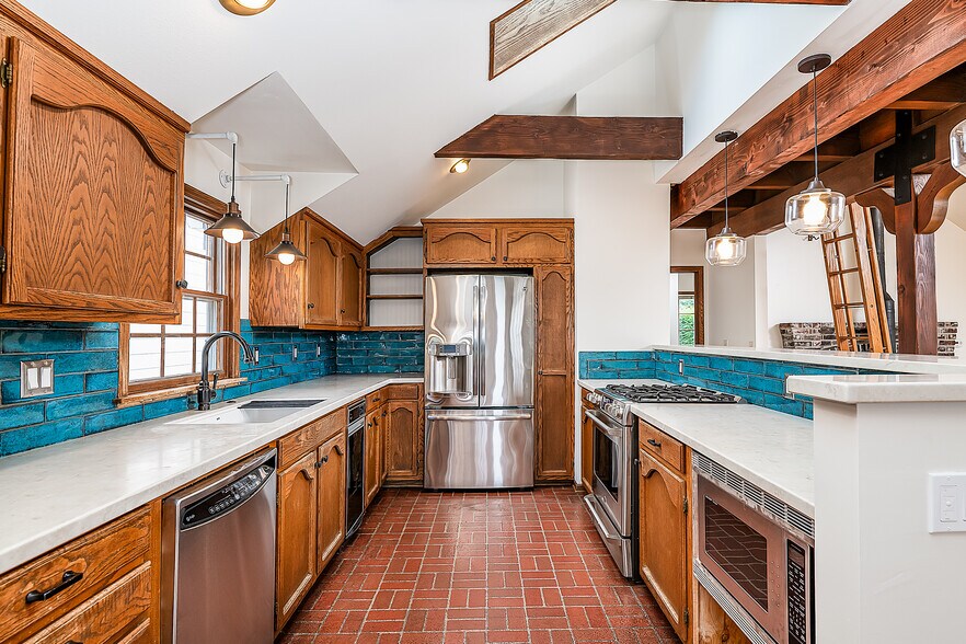 Kitchen with new countertops and tile, almost new appliances - 22224 98th Ave W