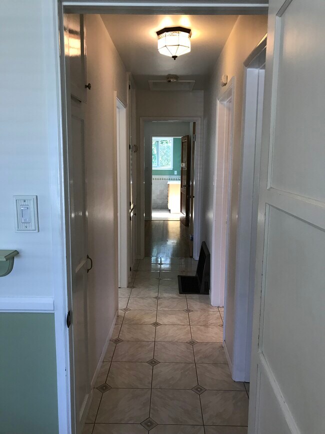 Hallway view from second bedroom to master bedroom and bath. Two closets provide ample storage. - 14911 Fonthill Ave