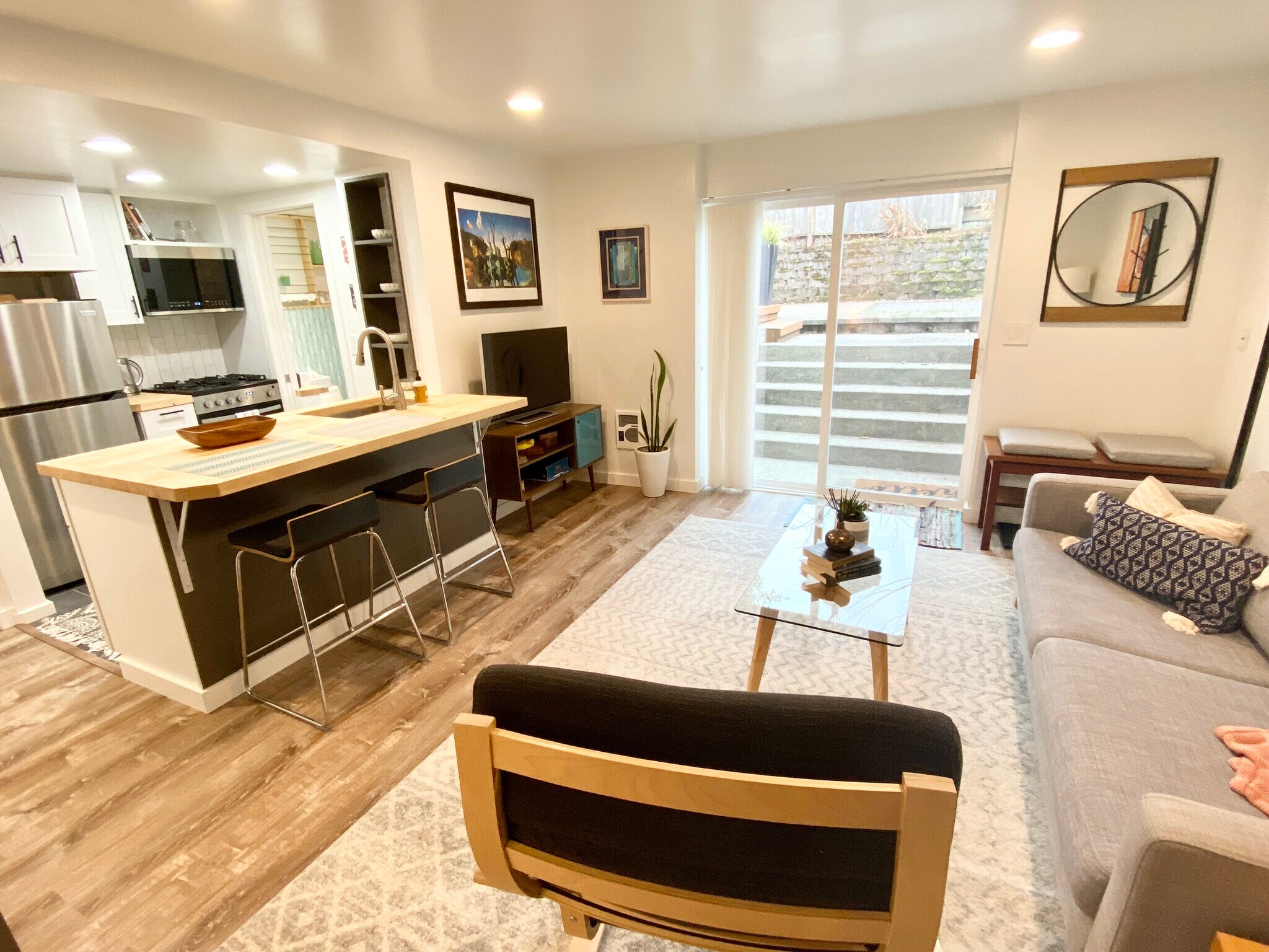 Spacious living room with counter height bar seating. - 4045 54th Ave SW