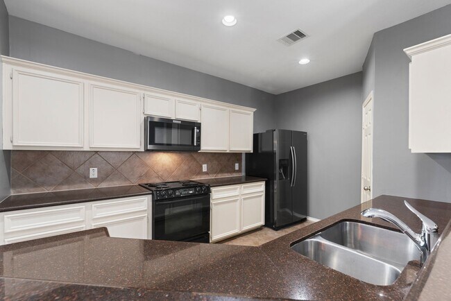 Building Photo - Come see this modern 3-story townhome in t...