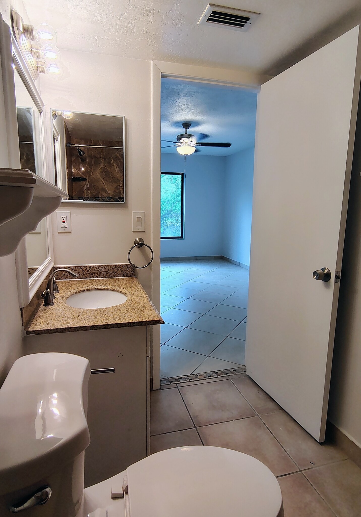 View from main BA through main BR; linen closet behind door - 1353 Pine Ridge Cir E