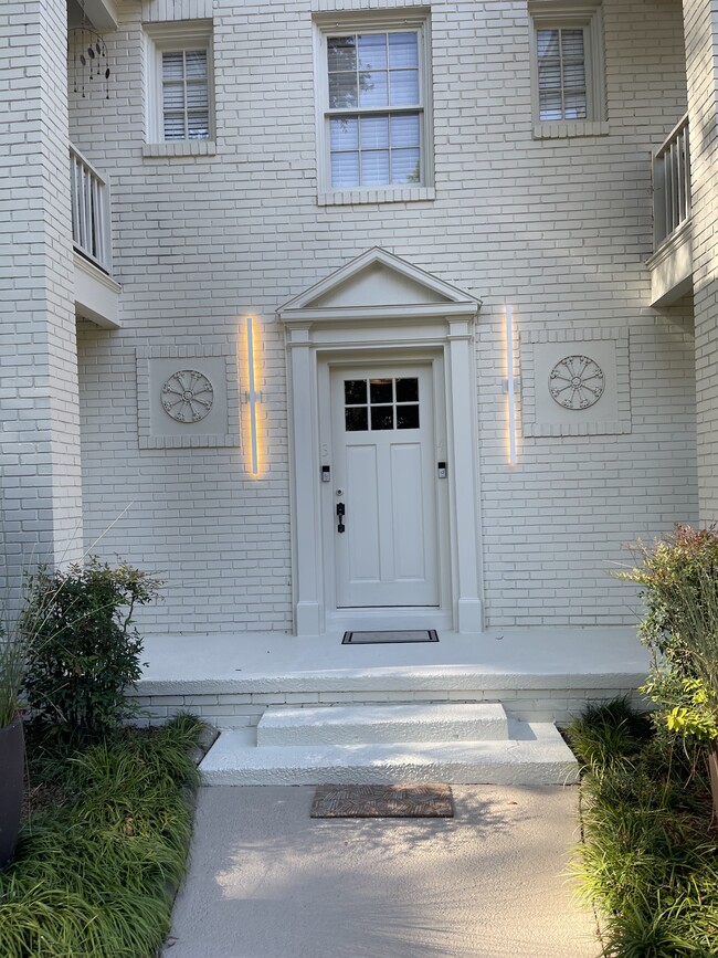 freshly painted cream building with new contemporary lights - 541 Lamar Ave