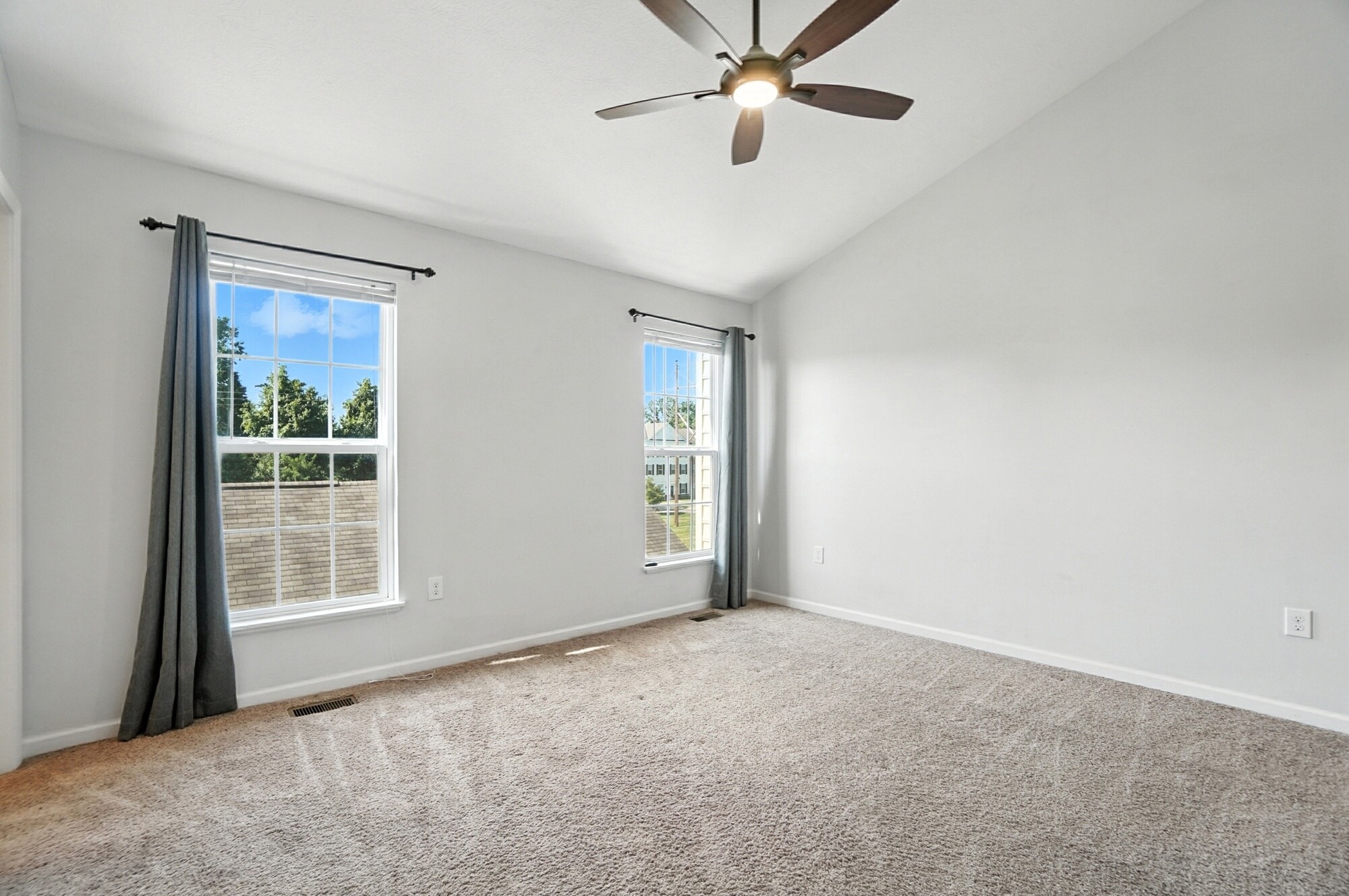 Primary bedroom with vaulted ceiling and remote control fan - 6169 Needletail Rd