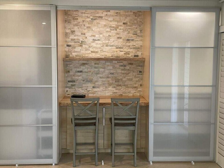 built in desk/counter flanked by the laundry center on the left and wardrobe on the right - 441 N Harbor City Blvd