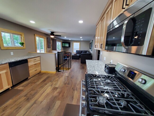 View to living area from kitchen, upper level (kitchen, bedrooms, living area, full bath) - 18629 Langly Ave N