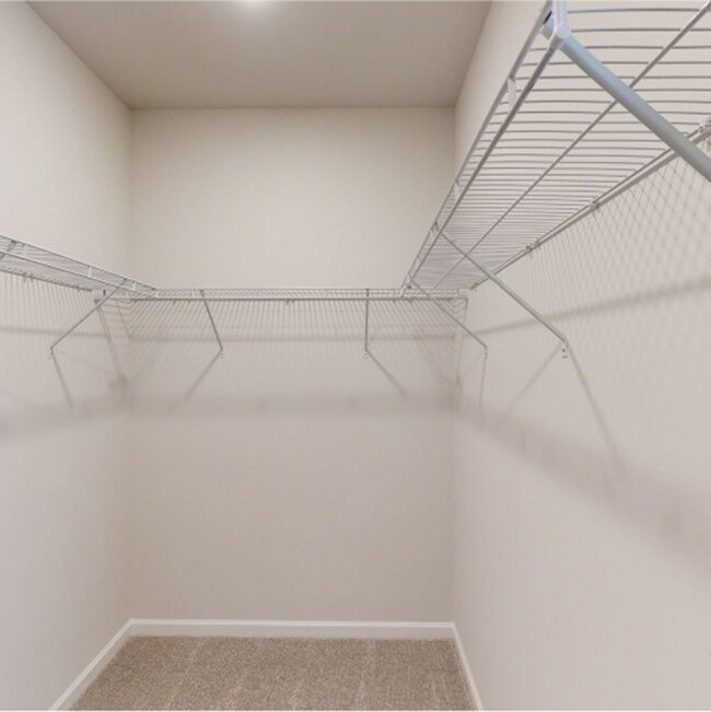 This large walk-in closet with built-in shelving is capable of storing the wardrobes of 2 occupants - 15580 Ruthie Lynn Dr