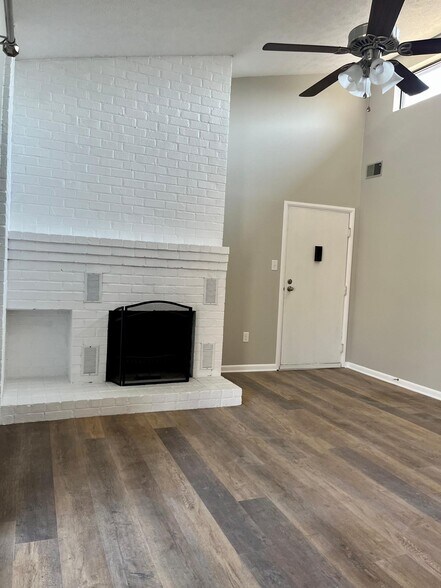Bright living room with wood burning fireplace, vaulted ceilings and new LVP flooring - 104 Turtle Creek Rd