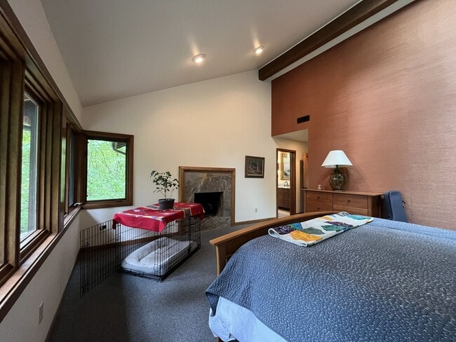 Building Photo - One-of-a-Kind Custom Home with Wall of Windows, Stone Fireplaces, Expansive Entertainment Space &...