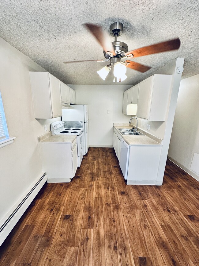 Explore a kitchen space that combines comfort with modern style. - Hawk Point Apartments