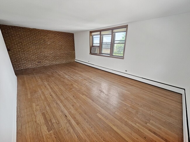 Building Photo - Mid-Century Modern 1-Bed + Den with Exposed Brick