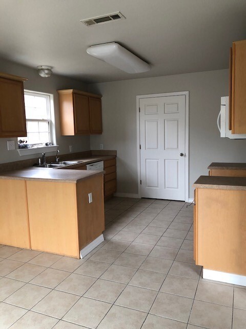 Kitchen, Stove hadn't been delivered at time of picture. Sliding glass door on opposite wall leading to fenced in backyard. - 3768 Grainger Cir