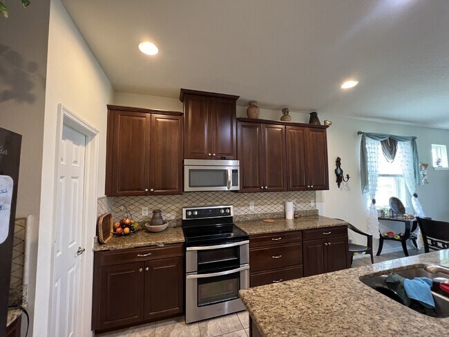 Building Photo - "Spacious 4-Bedroom Lutz Home with Elegant...