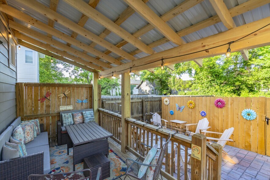 Back yard covered outdoor dining and open space seating area with firepit - 1922 14th Ave N
