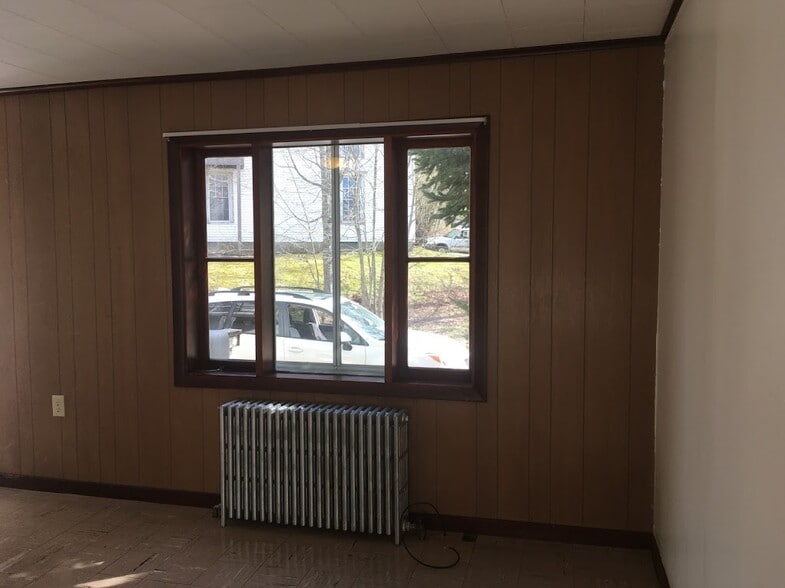 View out Living Room looking toward private parking area. - 16 Obrien Ave
