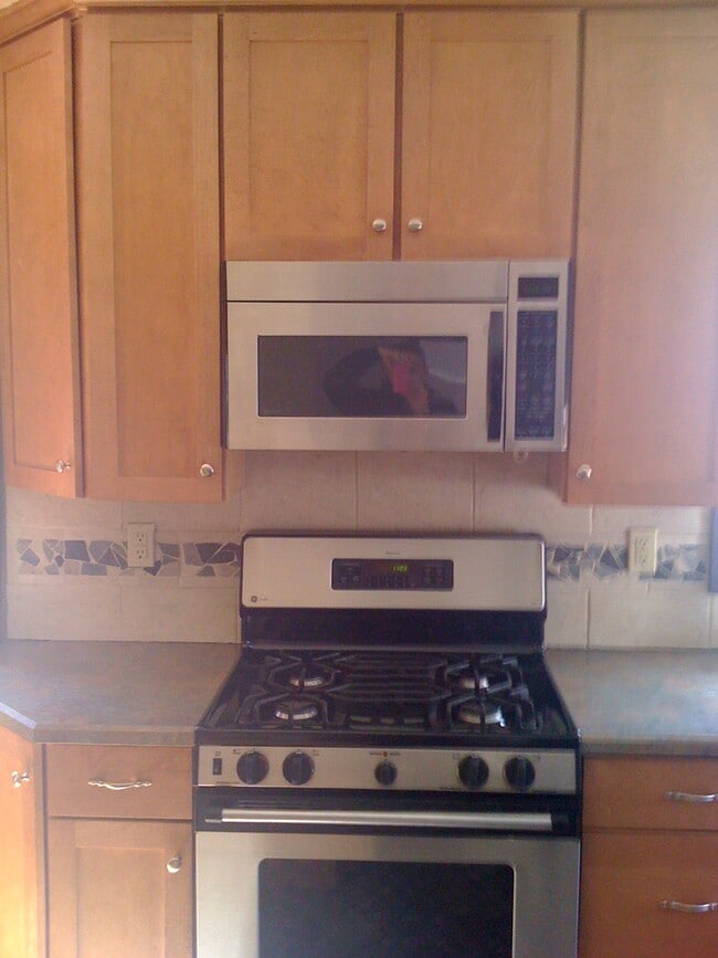 Stainless steel appliances in updated kitchen. - 3909 Perry Street