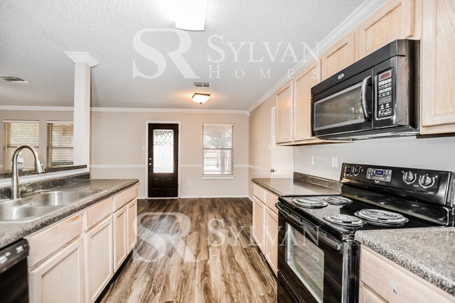 Building Photo - The living is easy in this gorgeous 4BR, 2.5BA brick home